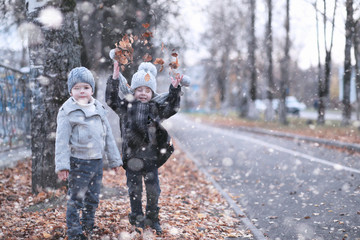 Kids walk in the park first snow