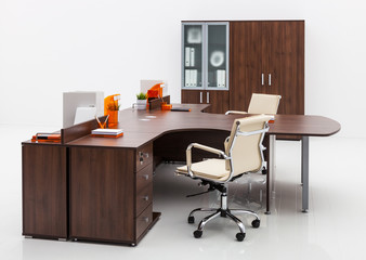 armchair, desk and bookcase on white wall