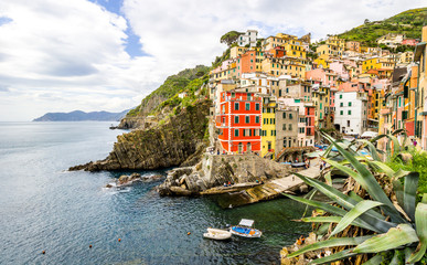 Fototapeta na wymiar beach streets and colorful houses on the hill in Riomaggiore in Cinque Terre in Italy 
