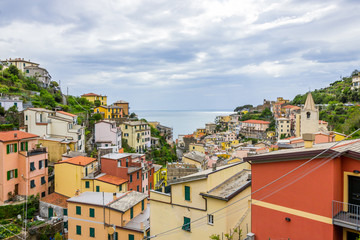 beach streets and colorful houses on the hill in Riomaggiore in Cinque Terre in Italy 