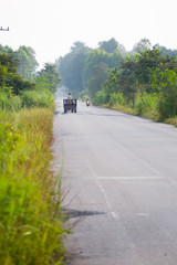 Farmer driving farn tractor (Thai peaple called  E-Tan ot E -tak).