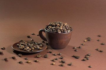 A cup of coffee beans in the brown background.