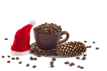 Fresh coffee beans, a New Year hat and a pinecone at the white isolated background.