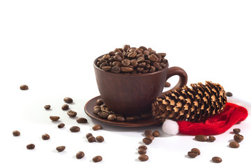 A cup with coffee beans and a New Year hat at the white background