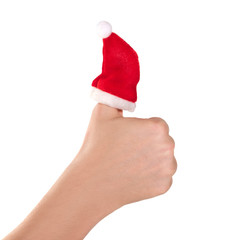 A red hat Santa claus on the thumb of hand is isolated on a white background