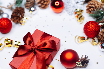 Christmas card: red gift box and Christmas tree branch on white background