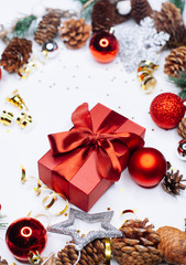 Christmas card: red gift box and Christmas tree branch on white background