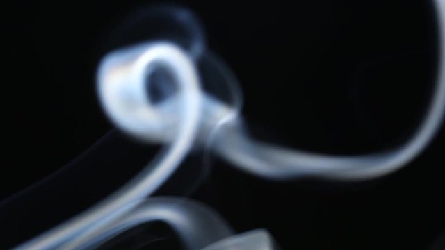 Aroma sticks smoke close up on black background