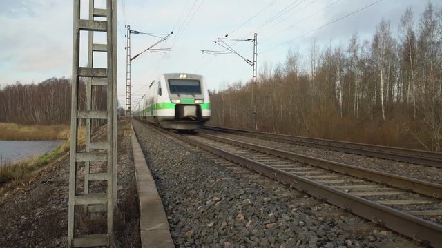 Train on railway passing by, very close next to the railroad