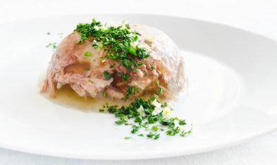 beef jelly decorated with parsley, dill, and garlic