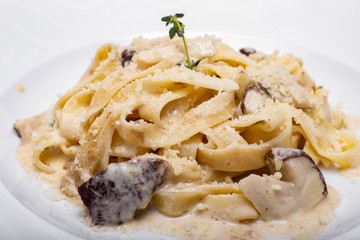 Pasta with white mushrooms in creamy sauce.
