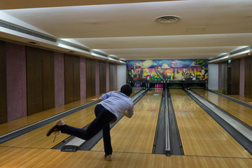 Man play bowling in a hall