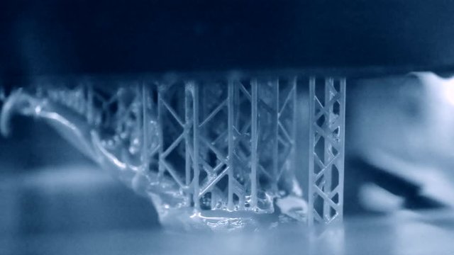Stereolithography DPL, SLA 3d printer creating shape by UV polymerization. close-up. Progressive modern additive technology 3D printing.