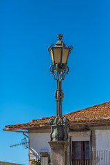 View of a classic street lamp post, house on background