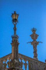 Fototapeta na wymiar View of a classic street lamp post, Pillory of Porto on background
