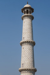 The  ivory -white marble minaret  the  Taj Mahal, the famous mausoleum in Agra, India.