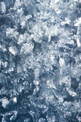 Macro look of snowflakes, snow crystals. Vertical abstract winter background