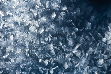 Macro look of snow crystals, snowflakes. Abstract winter background with copy space