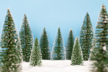 Obraz premium Landscape forest with christmas trees on the snow in winter. Christmas holiday celebration and new year concept. copy space