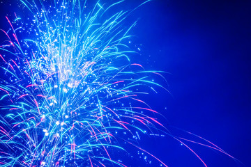 Brightly Colorful Fireworks on twilight background with copy space