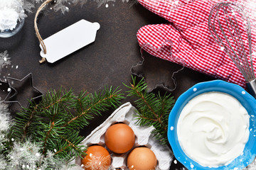 Ingredients for baking. Christmas card with decorations on concrete background. Christmas baking, cooking process.