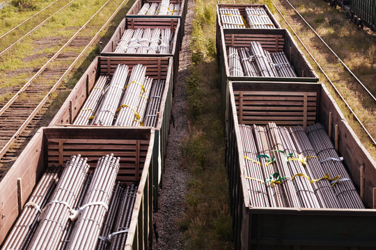two trains on the railroad cars which steel billets for pipes