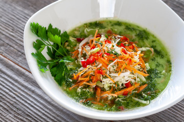 Vegetarian dish. Vegan green cabbage soup made from Chinese cabbage, carrots, peppers, tomatoes, avocados, pumpkin seeds and lemon juice, garnished with parsley.