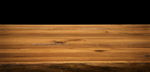 Wood desk isolated on black.