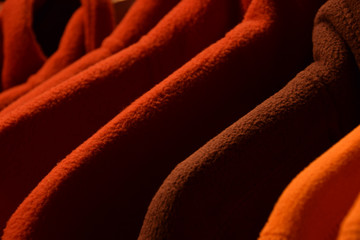 colorful fleece jackets, colorful polar fleece jackets on a hanger macro shot made of recycled...