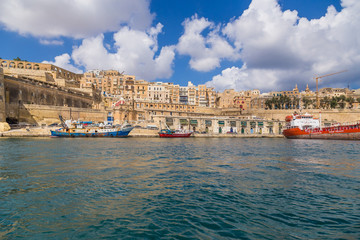 Valletta, Malta. Ships at the pier on the background of the city and the old fortress