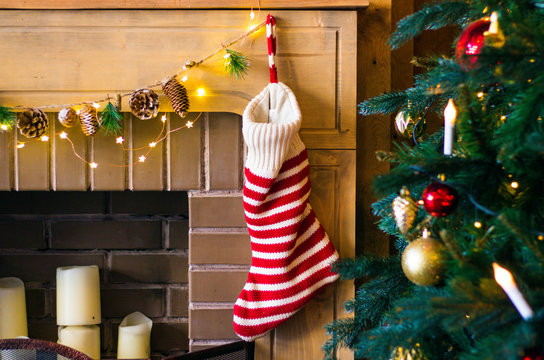 Christmas decorations stocking and toys hanging over the fireplace