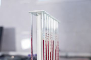 Medical clinic. A stand with pipettes filled with blood. Close up