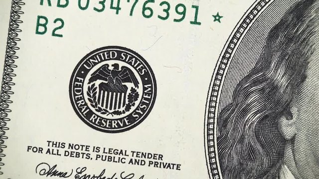 Federal Reserve System Seal on US 100 dollar bill rotating, money close up. 4K UHD video clip