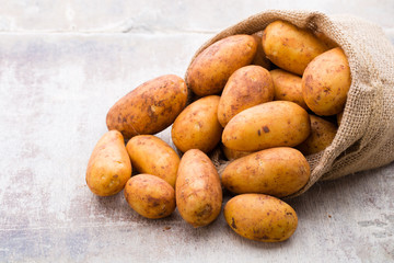 A bio russet potato wooden vintage background.