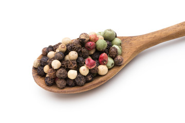 Pepper mix seed on spoon on white background.