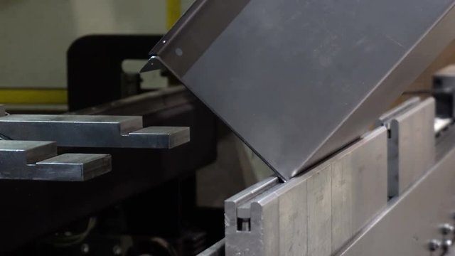 CNC bending machine. The machine bends the metal part