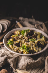 Homemade tortellini with mushrooms and walnuts