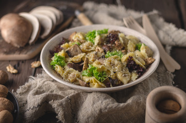 Homemade tortellini with mushrooms and walnuts