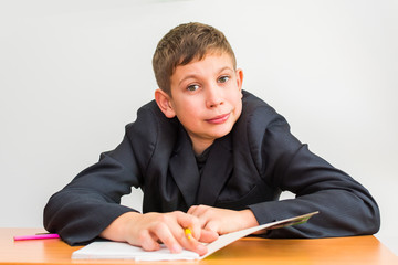 joyful boy at the Desk doing homework