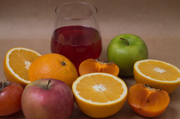 oranges and glass of juice on background