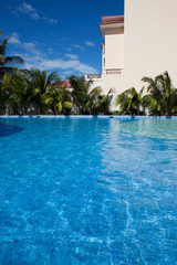 Wall of a building at pool and a palm tree