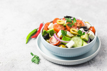 Avocado feta Greek salad in a bowl. Selective focus, space for text.