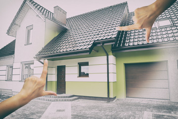 Female hands framing custom house design.