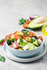 Avocado feta Greek salad in a bowl. Selective focus, space for text.