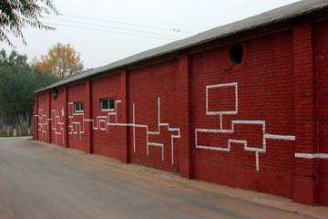 Fototapeta na wymiar Graphic symbol in dark red house on the wall