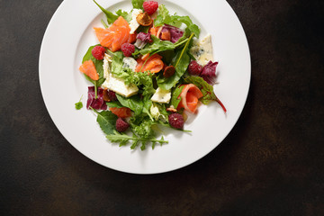 Fresh salad with salmon top view