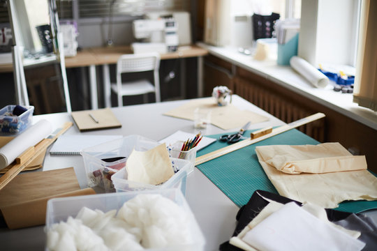 Workplace of tailor with assortment of fabric and other supplies for sewing