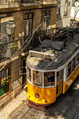 Yellow tram on the streets of Lisbon, Alfama, Portugal  - obrazy, fototapety, plakaty
