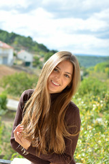Fototapeta premium portrait of a beautiful ,healthy and attractive young woman with long hair and beautiful face with outdoor background