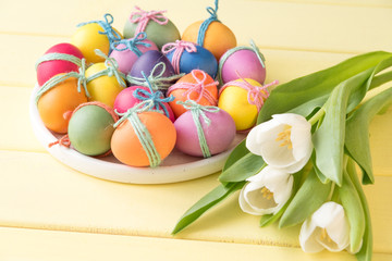 Easter eggs on a plate. Yellow background
